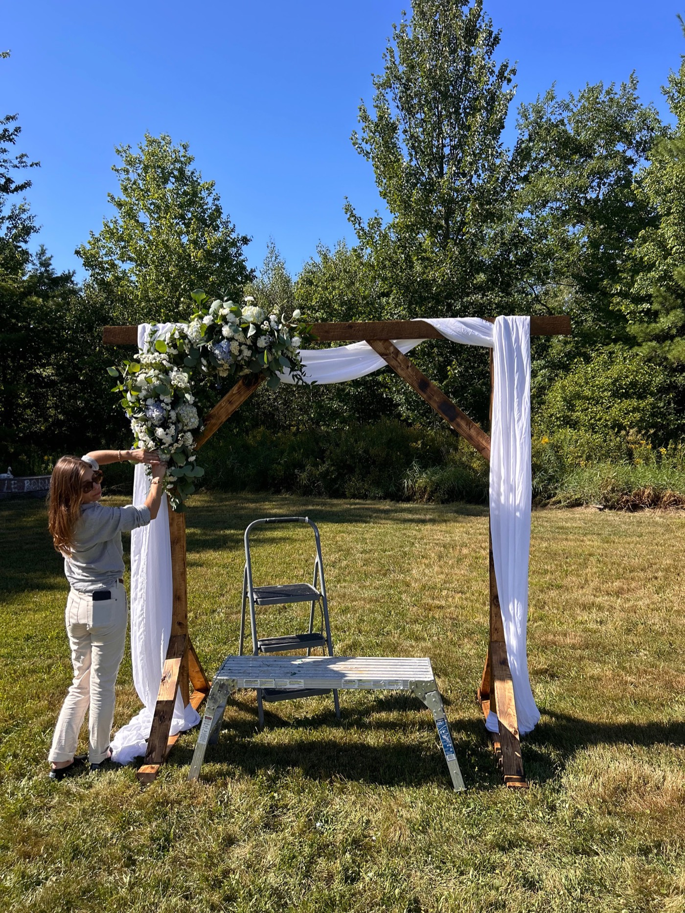 Wedding arch being styled for a ceremony